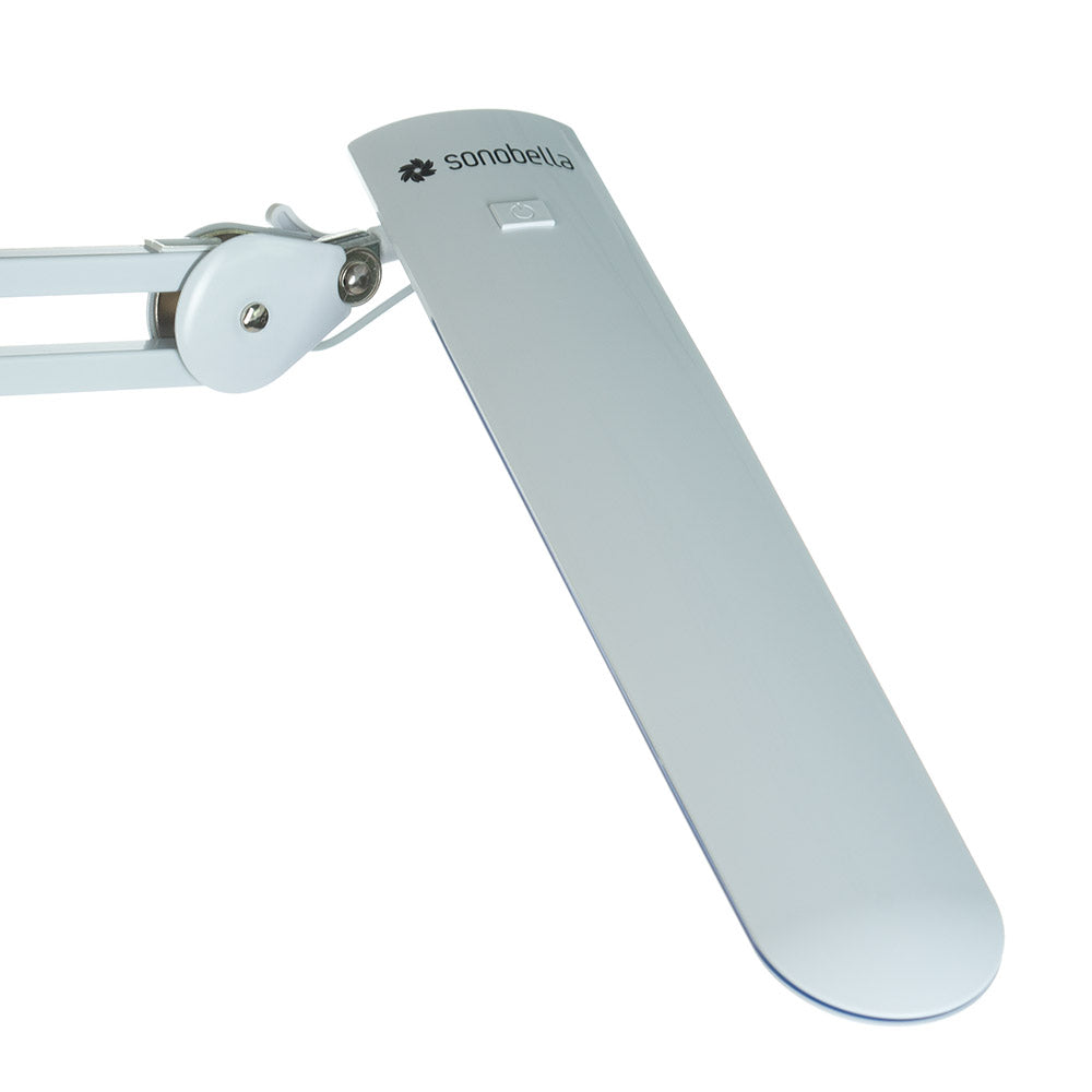 Sonobella Moon LED BSL-12 workshop lamp by Beauty System showing bright, adjustable LED light in a workspace setting.