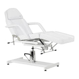 Hydraulic salon chair with reclining backrest and white upholstery