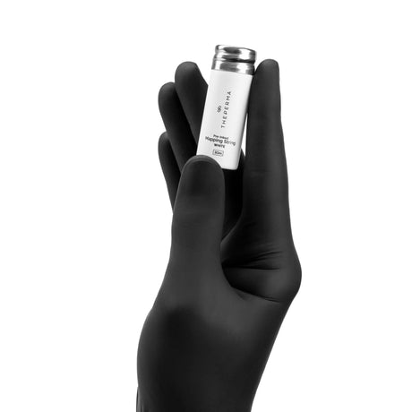 The Perma Mapping String Bottle in black, red, and white with a colorful string design and a clear plastic bottle body.