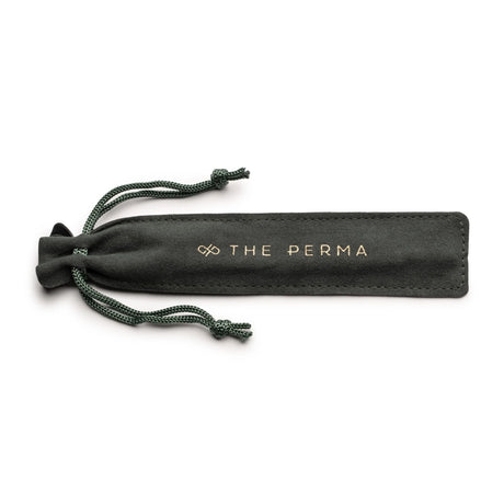 The Perma Microblading Holder by The Perma holding microblading tools on a clean workspace.